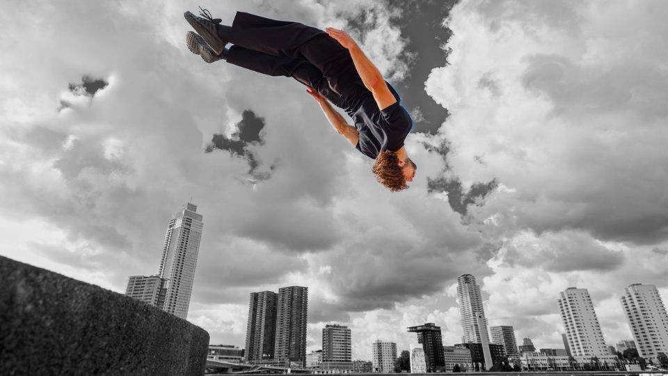 Siebe mid-backflip above the Rotterdam skyline